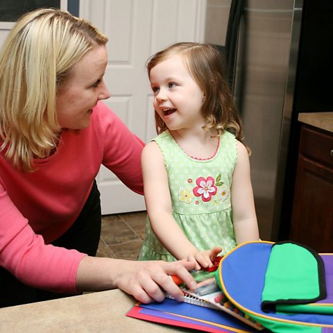 Mum packing schoolbag with daughter