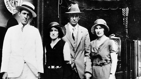 Jimmie Rodgers is stood to the left, wearing a white suit and hat, with Maybelle, AP and Sara Carter, stood to his side.