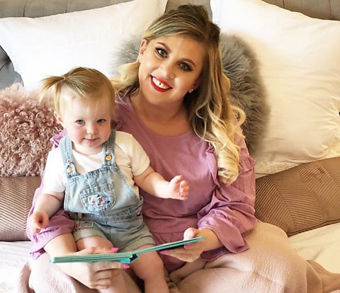 Louise Pentland and her child reading in bed