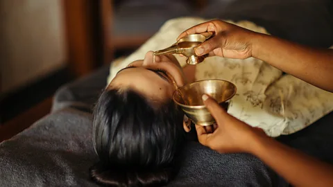 Amal Tamara Woman having Ayurvedic oil treatment