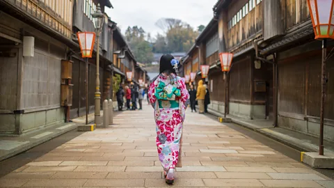 Getty Images Woman in kimono walking in traditional area of Kanazawa