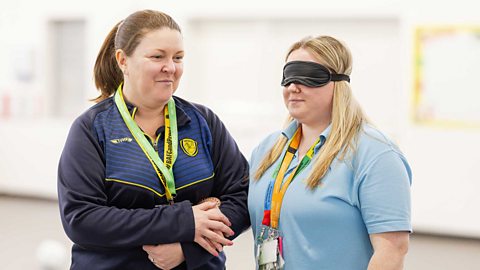 Teachers in a sports hall trying guided running