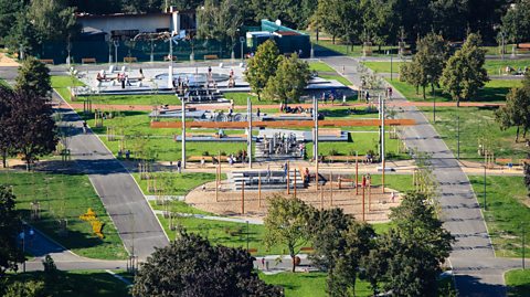 An aerial image of Malesicky Park in prague featuring trees, play equipment and an archimedes screw system of water carrying.