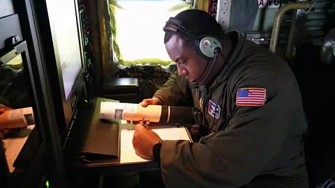 US Air force Tech. Sgt. Larry Banks checks a dropsonde during an atmospheric rivers mission in 2023 (Credit: US Air Force)