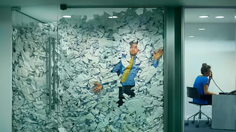 Getty Images Man pressed against paper against office window (Credit: Getty Images)