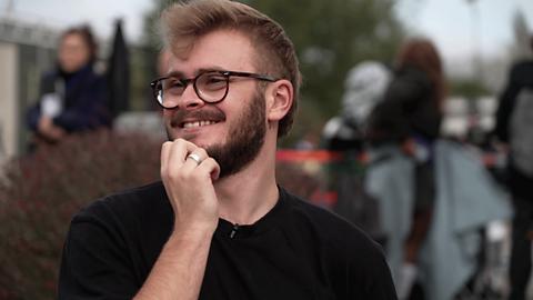 Floor runner, Sam, smiling on set of Phoenix Rise. 