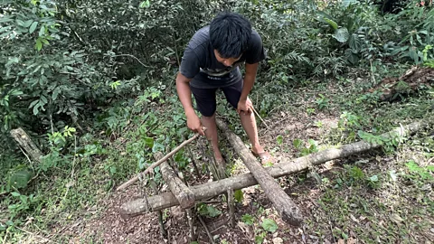 Megan Eaves On the Aldea Yvytu Porá’s eco-trail, a community guide demonstrates simple traps used to sustainably manage wildlife (Credit: Megan Eaves)