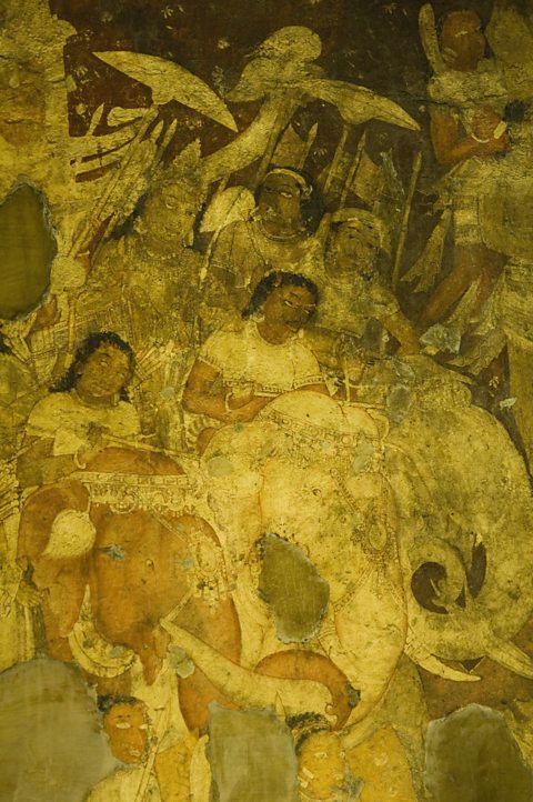 A faded wall painting, with a yellowish tint, showing Indian women riding on elephants