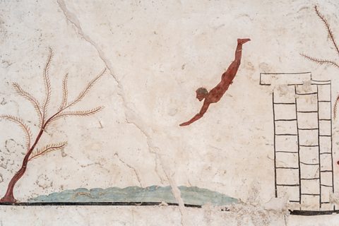 A stark white fresco with a male figure diving of a platform into water below