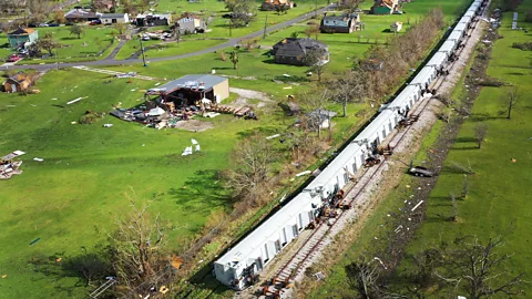 Getty Images A derailed train amidst destroyed buildings of Lake Charles in the aftermath of hurricane Laura (Credit: Getty Images)