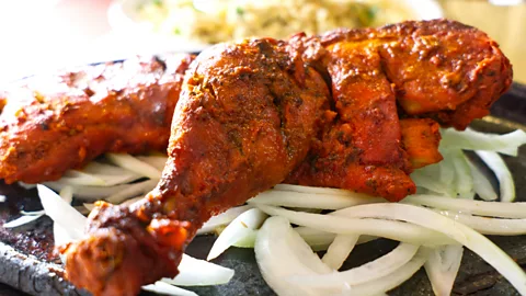 Getty Images The dish was created by adding a tomato-based gravy, butter and spices to leftover tandoori chicken (Credit: Getty Images)
