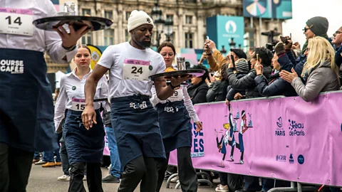 Alamy The recent "Waiter's Race" saw 200 Parisian servers dash 1.9km through the city balancing coffee, a croissant and water (Credit: Alamy)
