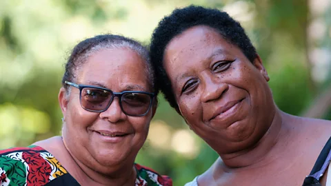 Damir Ali Mary Romany-Constantine (left) and her sister Julie have both participated in a program to use vetiver to help stabilise the land their homes are built on (Credit: Damir Ali)