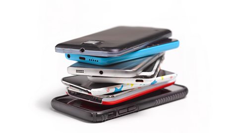 A pile of phones on a white background