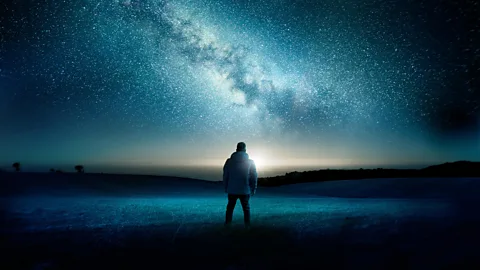 Alamy Man by the water looking at starry sky (Credit: Alamy)