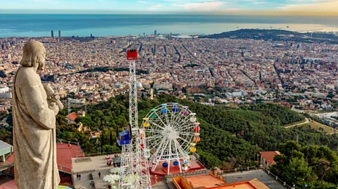 Alamy Hiking up Tibidabo Hill will yield amazing views of the city and a chance to visit Barcelona's historic amusement park (Credit: Alamy)