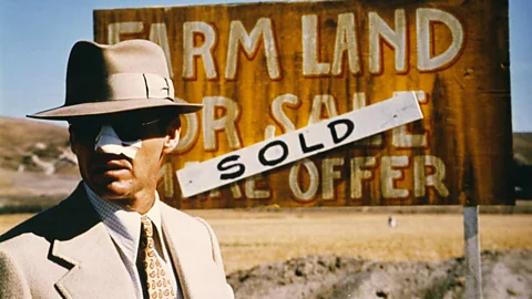 Alamy Jack Nicholson in front of "Farmland sold" sign (Credit: Alamy)