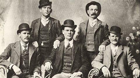 The Wild Bunch, American outlaw gang, 1901. Left to right, standing, William Carver (News Carver), Harvey Logan (Kid Curry); sitting, Harry Longabaugh (Sundance Kid), Ben Kilpatrick (The Tall Texan), Robert LeRoy Parker (Butch Cassidy). They are sat in tweed suits with bowler hats.