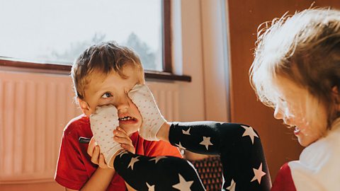 Brother and sister annoying each other