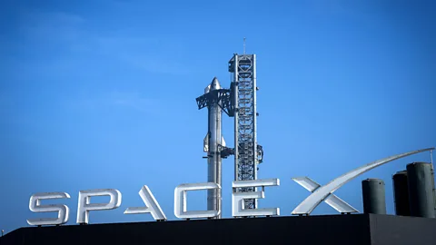 Getty Images SpaceX logo and Starship rocket in background (Credit: Getty Images)