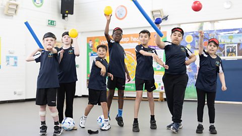 Group of children throwing para athletics sport equipment