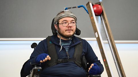 Rafael Young playing boccia using a head placer