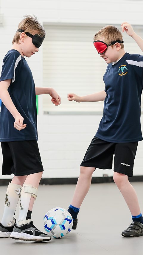 Two children playing blind football