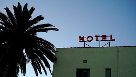 Red hotel sign on the roof of a builidng