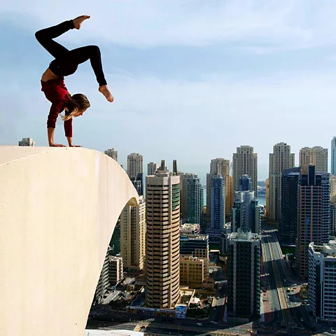 Netflix Angela Nikolau, shown here performing an acrobatic stunt against the skyline, is the daughter of circus performers (Credit: Netflix)