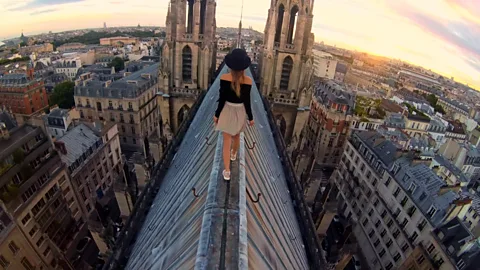 Netflix The film shows Nikolau – pictured walking on church roofas visibly afraid when attempting the gravity-defying stunts (Credit: Netflix)