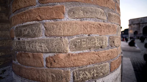 Getty Images The walls and pillars of Rome's Colosseum serve as a reminder of bad tourist behaviour (Credit: Getty Images)