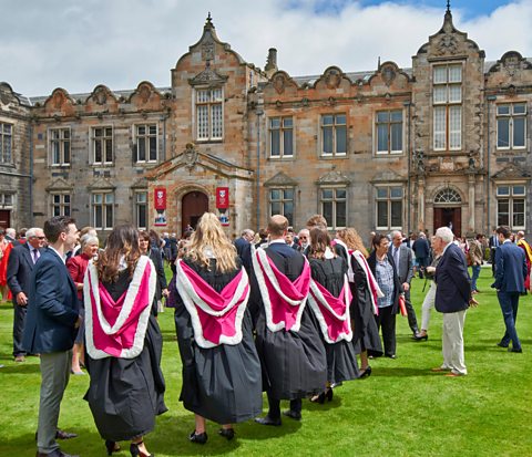 St Andrews University students at graduation in colourful gowns.