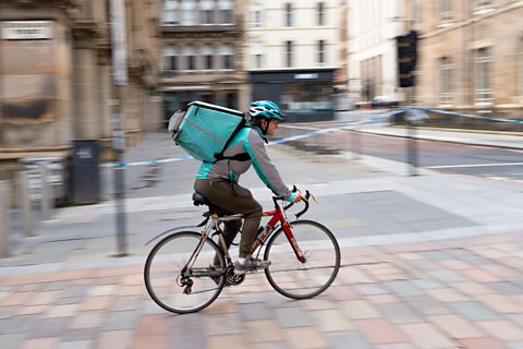 Takeaway food delivery couriers on cycles in Glasgow city centre.