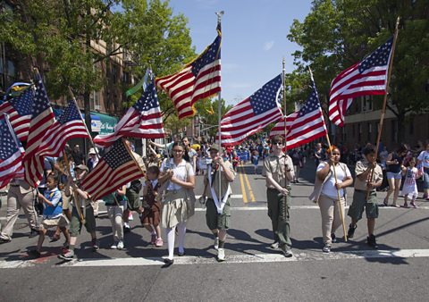 Boy Scouts and Girl Scouts march in the Memorial Day Parade in America.