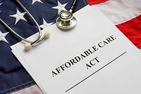 Affordable Care Act ACA, US flag and stethoscope.