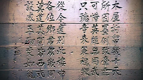 Alamy Visitors can still see Chinese characters carved into the walls of Angel Island's immigration and internment centre (Credit: Alamy)