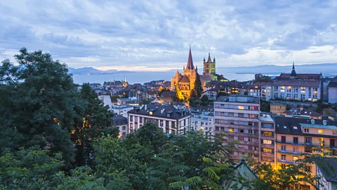 Getty Images Lausanne is set in a picture-perfect lakeside setting framed by Alpine mountains (Credit: Getty Images)