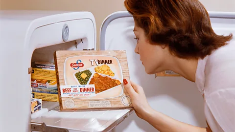 Getty Images Woman taking 1950s TV dinner out of freezer (Credit: Getty Images)