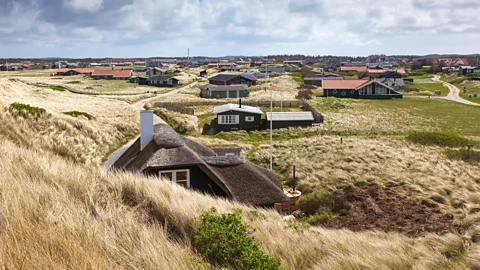 Getty Images The houses in Klitmøller are nestled among the dunes (Credit: Getty Images)