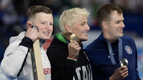 Getty Images UK swimmer Adam Peaty holds his silver medal for the 100m breaststroke final beside gold medalist Nicolo Martinenghi and silver medalist Nic Fink (Credit: Getty Images)