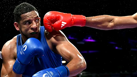 Getty Images O espanhol Enmanuel Reyes Pla leva um soco do belga Victor Schelstraete nas quartas de final do boxe masculino de 92 kg (Crédito: Getty Images)