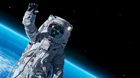 ISS astronaut in spacesuit against background of Earth.