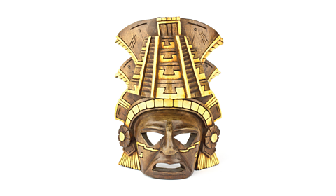 Image of brown and gold Mayan mask