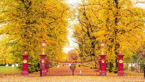 The large red iron gates of Victoria Park, Glasgow