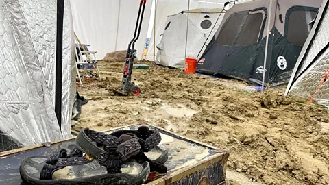 Getty Images In 2023, torrential rain turned the Burning Man site into a mud bath (Credit: Getty Images)