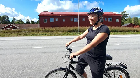 Matilda Welin Matilda Welin wearing a helmet on her bike on a road with a red building in the background (Credit: Matilda Welin)