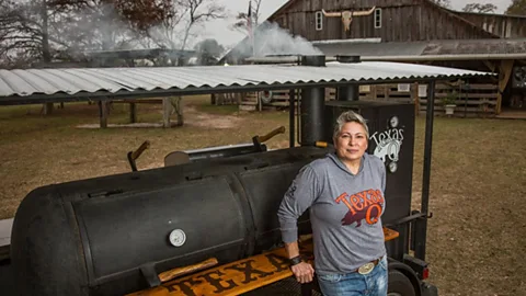 Amanda White Sloan Rinaldi in front of a grill (Credit: Anderson Group)