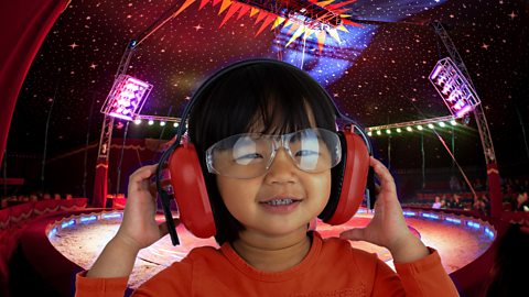 boy wearing ear defenders at the circus