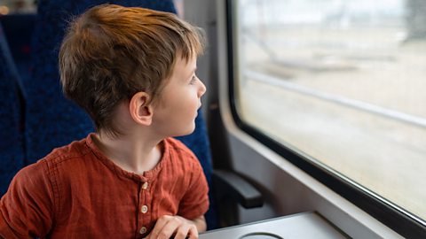 Boy looking out train window