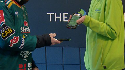 Ice hockey fan getting ticket scanned